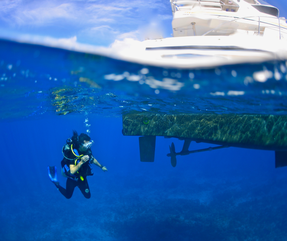Someone scuba diving off a yacht in Turks & Caicos